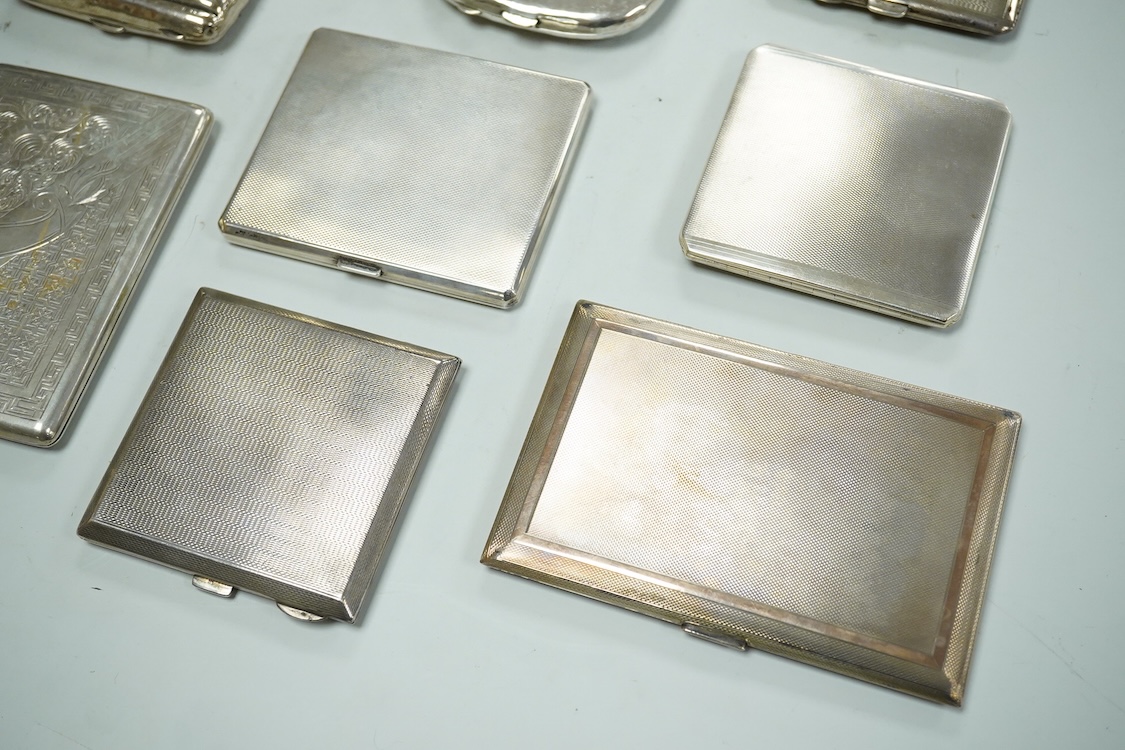 Nine assorted silver cigarette cases, including an Edwardian ribbed case and an engine turned rectangular case by Garrard & Co, Birmingham, 1960, 12.7cm, 32.1oz and one other unmarked white metal cigarette case.